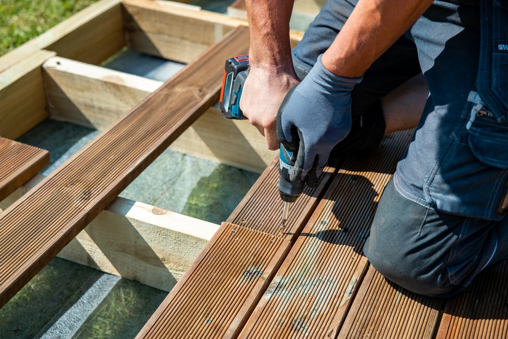 Deck,Construction,,Builder,Hand,With,Electric,Screwdriver,Installing,Impregnated,Wooden